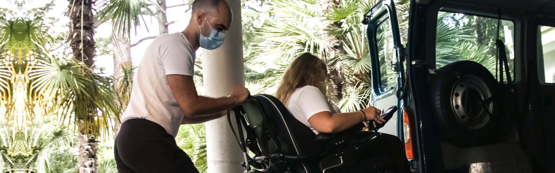 a man helping a woman getting inside a vehicle