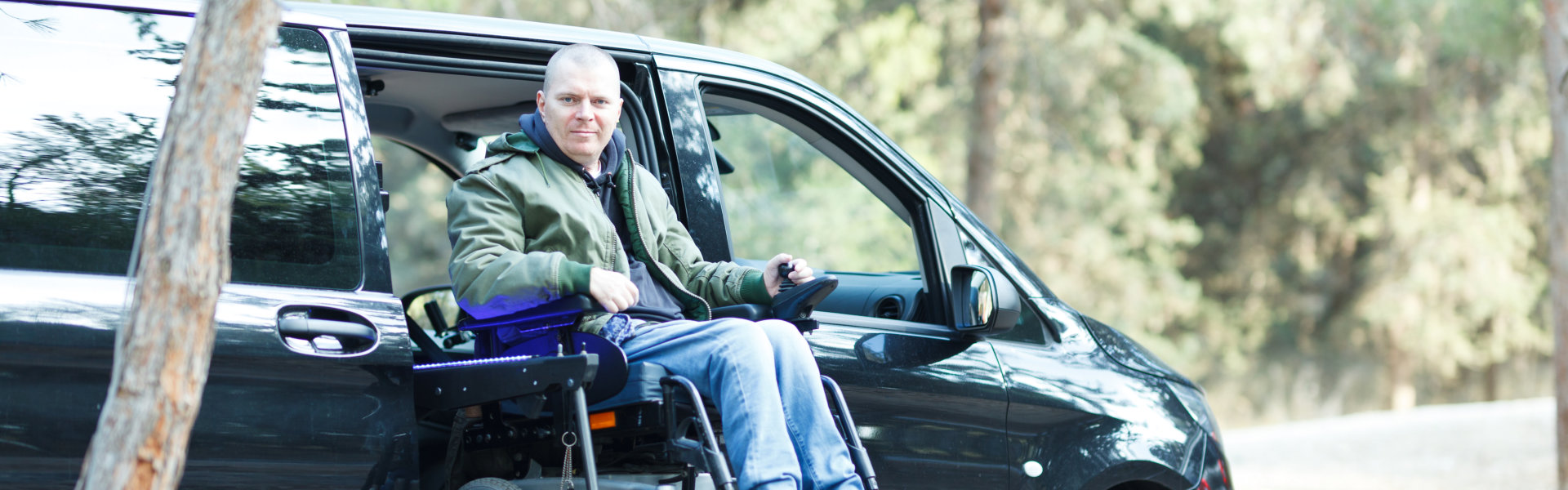 a man getting out of a vehicle smiling